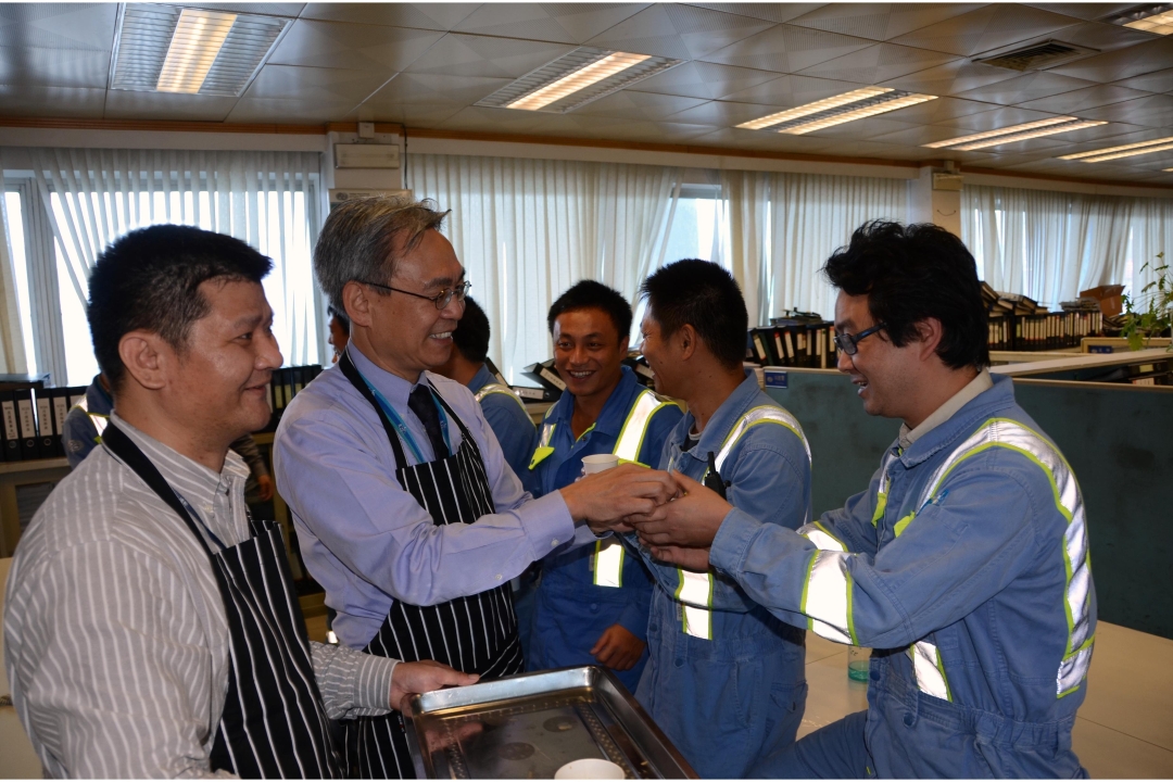 Managers and executives serving the staff a cup of tea